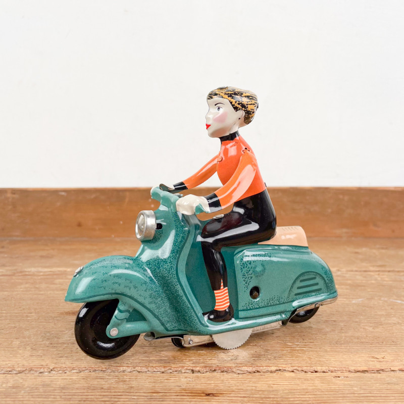 Girl on green mechanical scooter