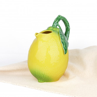 Carafe Bordallo Pinheiro on a white tablecloth, natural light