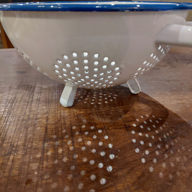 White enamel colander with blue border