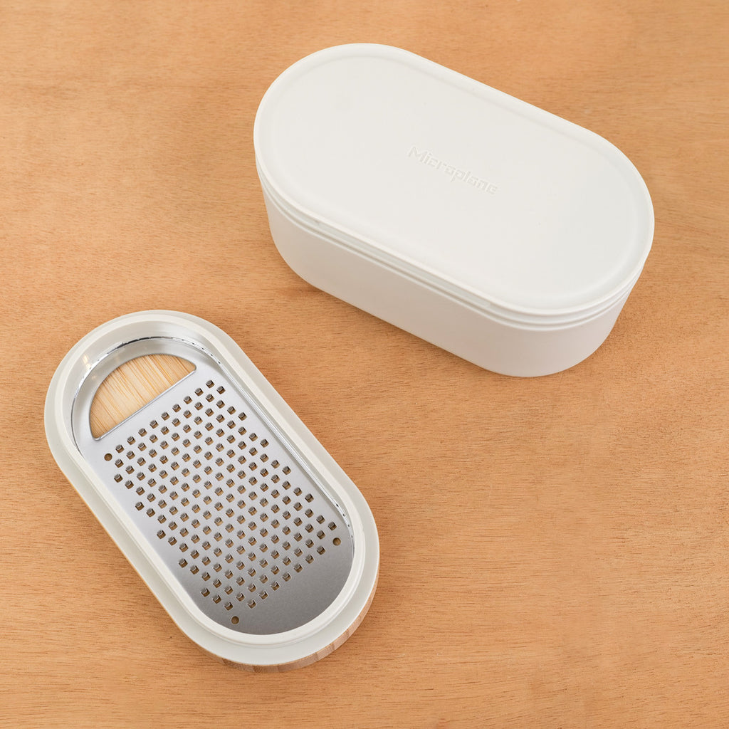 Grater with container and wooden lid