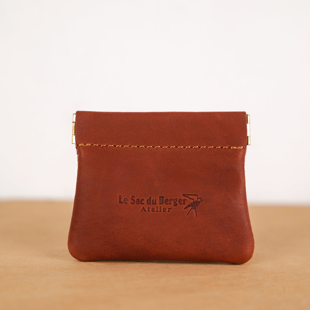 Tan leather kiss-lock coin purse