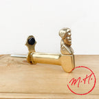 Brass shutter stop with man / shepherdess head