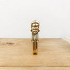 Brass shutter stop with man / shepherdess head