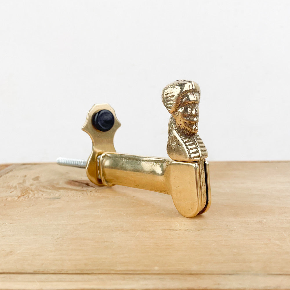 Brass shutter stop with man / shepherdess head