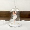Hanging ballerina under dome