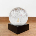 Dog in the woods snow globe