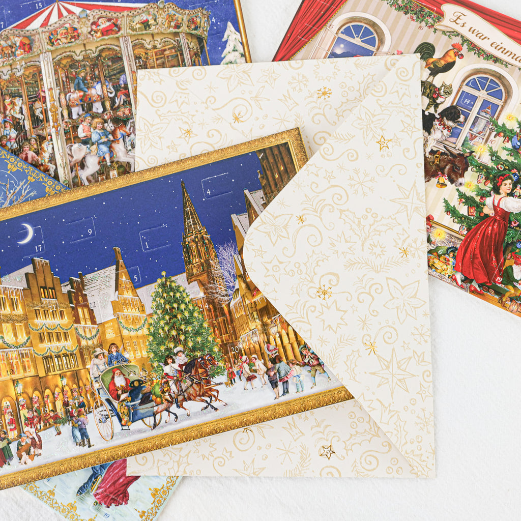 German Christmas greeting card with cream gold-patterned envelope, snowy town scene and sleigh