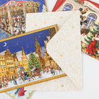 German Christmas greeting card with cream gold-patterned envelope, snowy town scene and sleigh