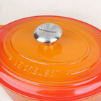 Gros plan sur le couvercle et son bouton inox d'une cocotte ovale Le Creuset Volcanique en fonte émaillée, fabrication française