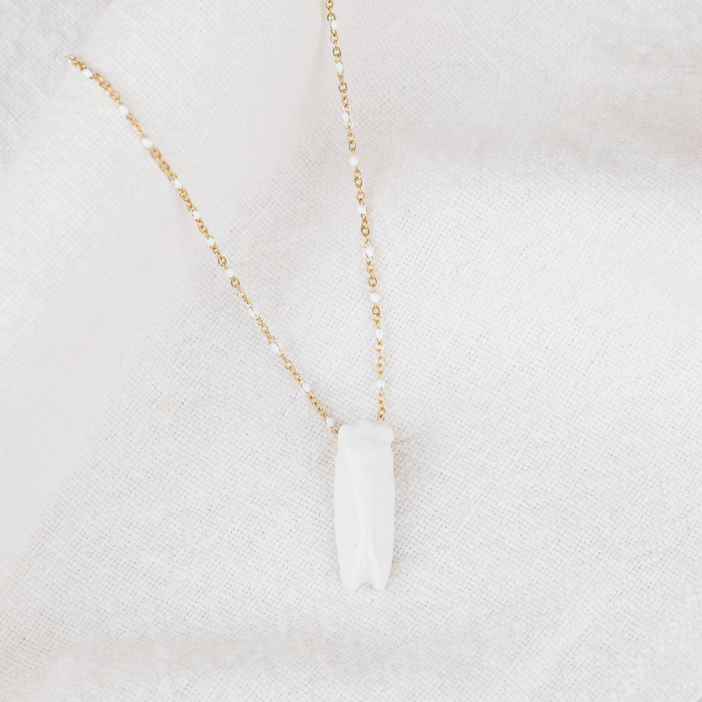 White and gold cicada necklace