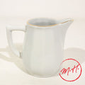White porcelain creamer with gold rim