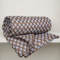 Brown quilt with blue flowers