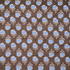 Brown quilt with blue flowers