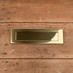 Brass letterbox plate with spring