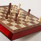 Pièces d'échecs en bois bicolores disposées sur l'échiquier magnétique Goki 56919, coffret 25x25 cm avec tiroirs laqués rouge