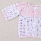 White and pink cotton layette