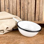 White enamel colander with black border
