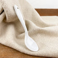 Small white porcelain spoon
