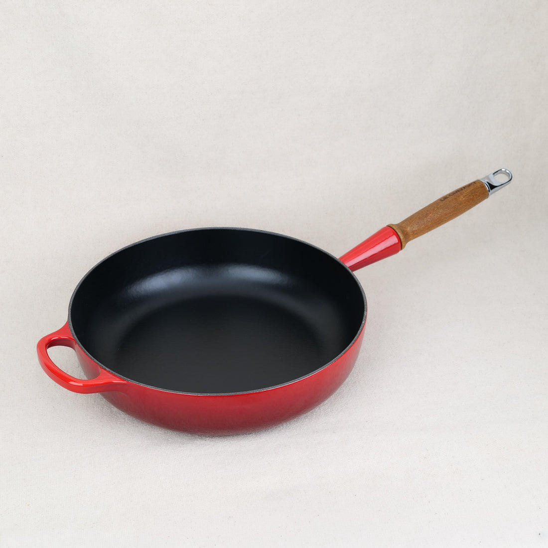 Le Creuset 28cm enamelled cast iron sauté pan in Cerise, wood handle, deep sides for braising, made in France