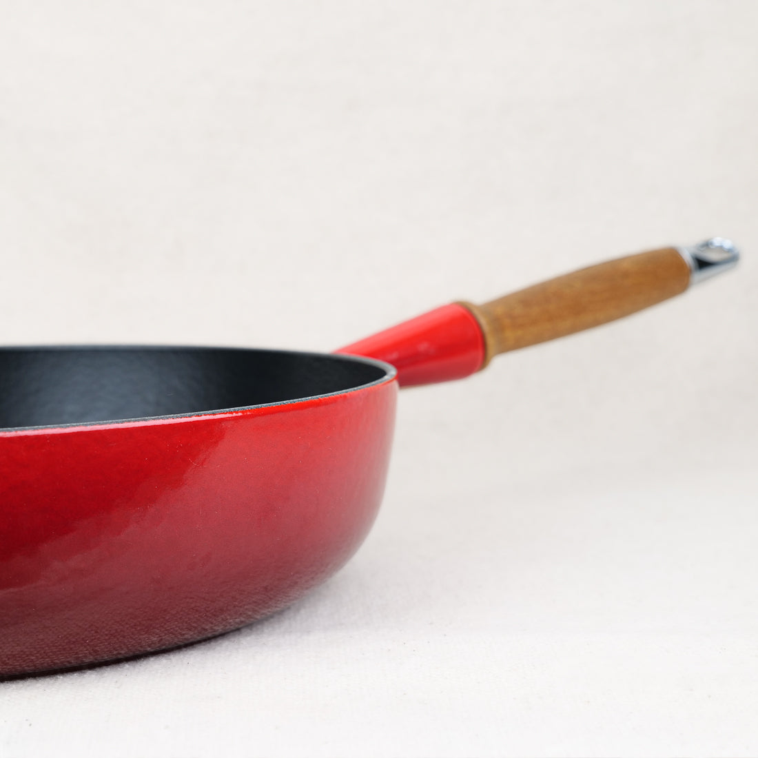 Le Creuset 28cm enamelled cast iron sauté pan in Cerise, wood handle, matte black interior, made in France, induction compatible