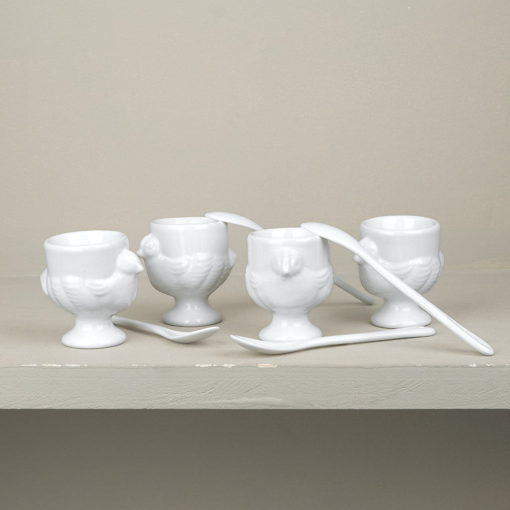 Set of 4 porcelain egg cups and teaspoons