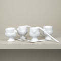 Set of 4 porcelain egg cups and teaspoons