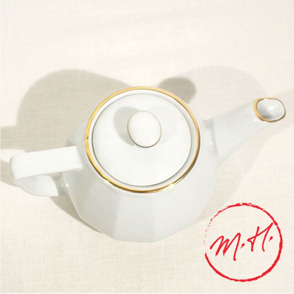 White porcelain teapot with gold rim