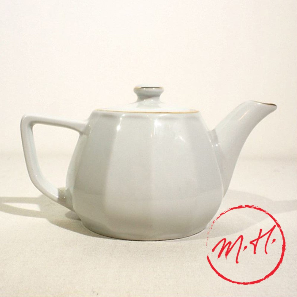 White porcelain teapot with gold rim