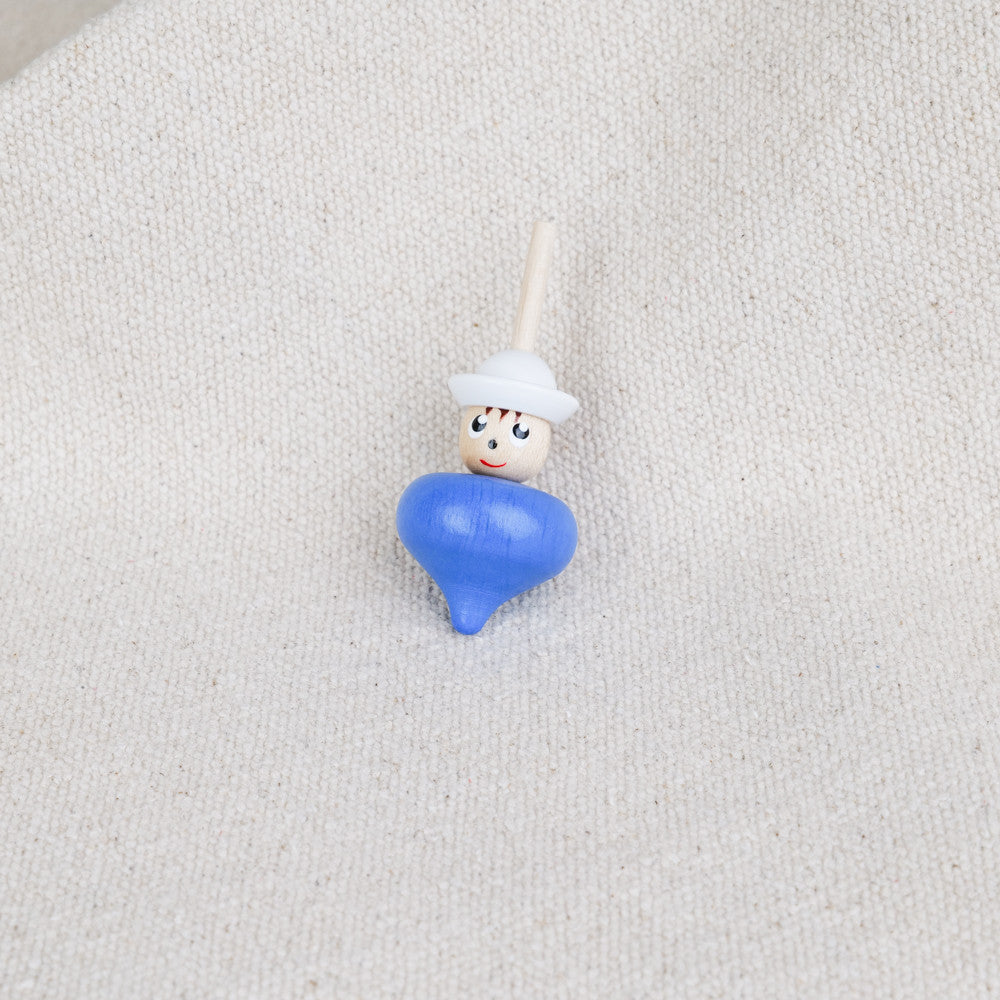 Small blue wooden spinning top