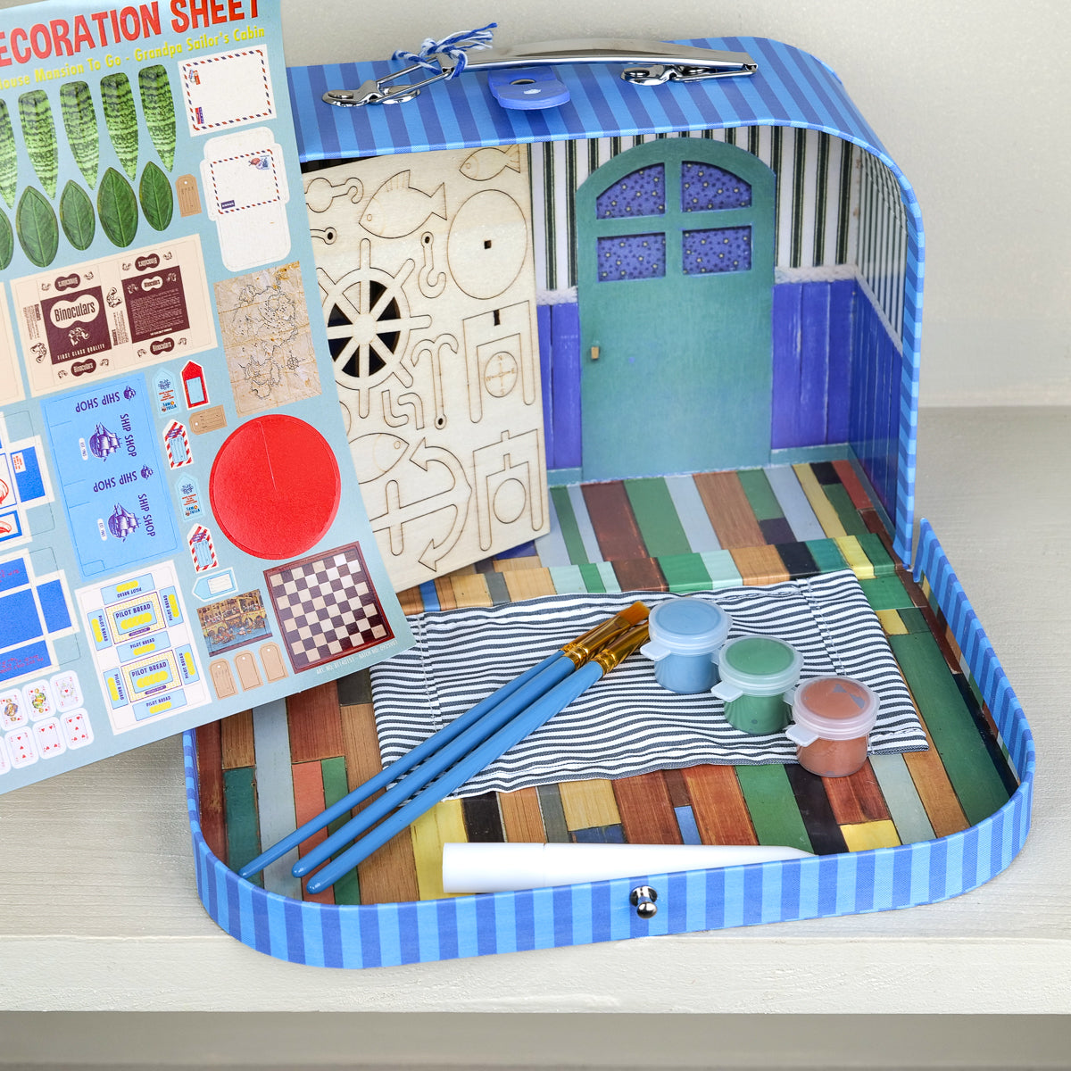 Cardboard suitcase craft kit with miniature sailor's cabin, blue striped case, for kids ages 4+